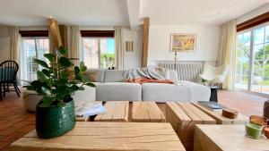 a living room with a couch and a table at House C - North Sea Stays in De Haan