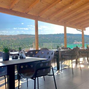 a patio with tables and chairs with a view at Vila Llanaj in Ksamil