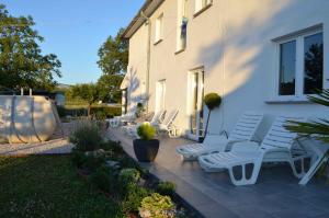 a group of white chairs sitting on a patio at Apartment in Potpican 9995 in Potpićan