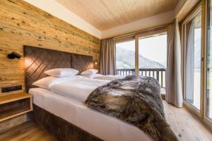 Posteľ alebo postele v izbe v ubytovaní NATURPARKGUT - alpdeluxe Apartments