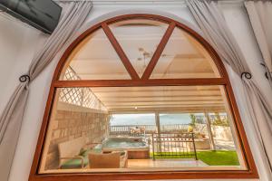 a large window in a house with a view of a patio at Apartments Belvedere in Herceg-Novi