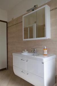 a bathroom with a white sink and a mirror at Il Roseto Mountain Lake Iseo Hospitality in Bossico