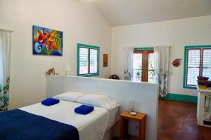 Un dormitorio con una cama con almohadas azules. en Apart-Hotel Garden Villa, en Las Galeras