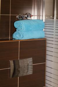 a group of blue towels on a shelf in a bathroom at Galini apartments Polyhrono in Kassandria