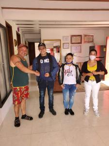 a group of people standing in a hallway wearing masks at Casa Hotel Villa Marta in Jericó