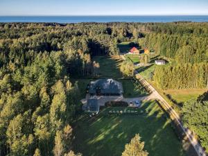 an aerial view of a house on a field with trees at Putnu pirts in Saulkrasti