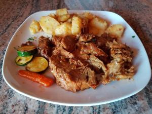 a plate of food with meat and potatoes and vegetables at Room in Rakovica with WiFi 4958-5 in Rakovica