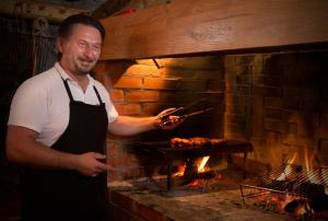 a man standing in front of a brick oven at Room in Rakovica with WiFi 4958-5 in Rakovica