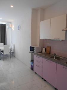 a kitchen with a sink and a counter top at Apartman Čarija in Trogir