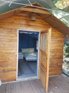a small wooden shed with a bed in it at XeniCamp-Retreat in Nafplio