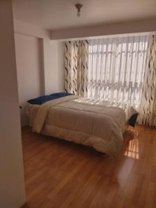 Apartamento Familiar Cusco tesisinde bir odada yatak veya yataklar