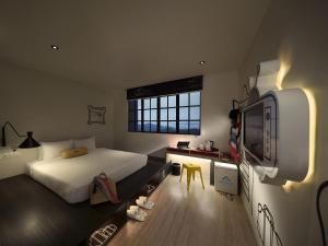 a bedroom with a bed and a tv in it at Resorts World Genting - Genting SkyWorlds Hotel in Genting Highlands