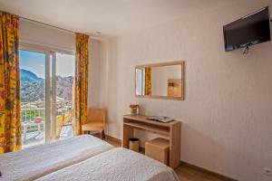 TV a/nebo společenská místnost v ubytování Hotel Kalliste