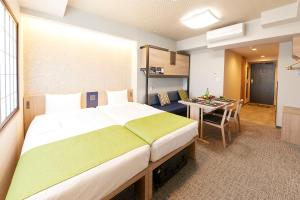 a bedroom with a large bed and a dining room at MONday Apart Premium UENO in Tokyo