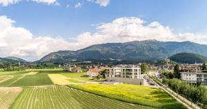 a view of a city with mountains in the background at Bellevue Bruneck - Suites & Lofts in Brunico