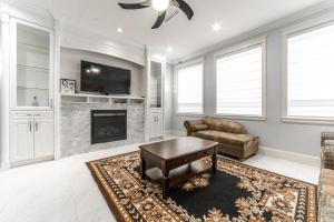 a living room with a couch and a fireplace at Michael's Lodge in Surrey