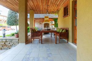 a patio with a table and chairs and a fireplace at Villa Aurora, komplex Sozopolis in Sozopol