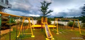 a playground with a yellow swing and a slide at 8 JOAQUIN'S Place WIFI Free! in Antipolo