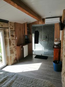 a bathroom with a shower with a glass door at La salamandre in Vic-le-Comte