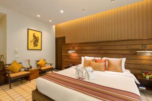 A bed or beds in a room at Khaolak Wanaburee Resort - SHA Plus Sandbox