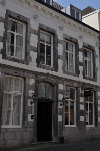 an old brick building with a door and windows at Boutique hotel Sint Jacob in Maastricht
