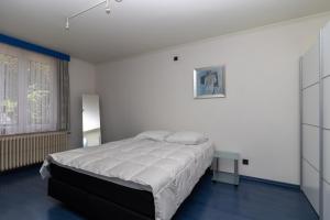 Кровать или кровати в номере Vakantiehuis Salamander Maasmechelen