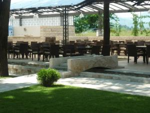 a group of tables and chairs in a patio at Hotel Vukov Most in Nikšić