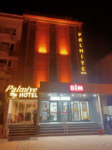 a building with a hotel sign in front of it at Palmiye Royale Palace in Edirne