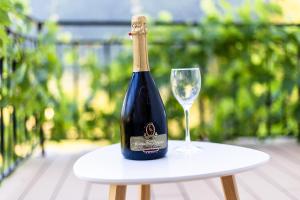 a bottle of wine and a glass on a table at Garden 13 in Tolmin