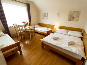 Posteľ alebo postele v izbe v ubytovaní Apartamenty i Pokoje u Doroty