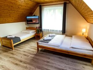 Posteľ alebo postele v izbe v ubytovaní Apartamenty i Pokoje u Doroty