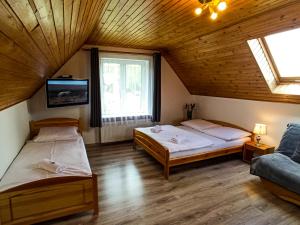 Posteľ alebo postele v izbe v ubytovaní Apartamenty i Pokoje u Doroty