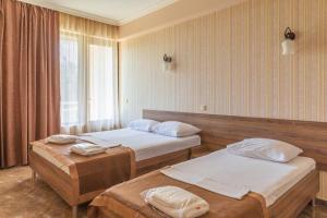 Postel nebo postele na pokoji v ubytování Samni Hotel