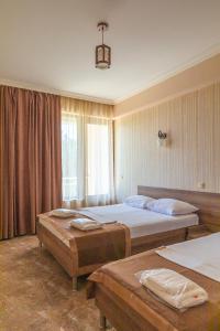 Postel nebo postele na pokoji v ubytování Samni Hotel