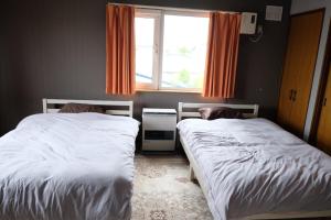 Postel nebo postele na pokoji v ubytování 富貴の里レジデンス + 25 fotografií