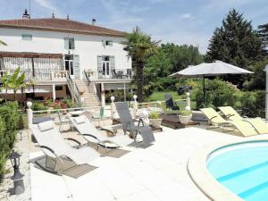 a patio with chairs and a swimming pool at La Batisse in Saint-Laurent