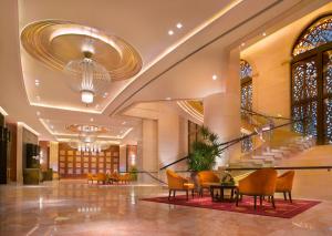a lobby of a hotel with chairs and tables at Banyan Tree Macau in Macau