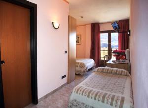 Postel nebo postele na pokoji v ubytování Hotel Les Saisons
