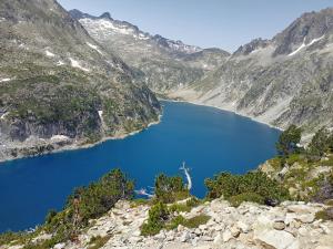 a view of a blue lake in the mountains at Résidence cambielh in Aragnouet