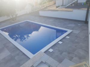 a pool in the middle of a patio at Villa Anđelo in Trogir