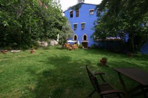 una casa azul con una mesa y sillas en el patio en Complejo Molí de L'Hereu, en Ráfales