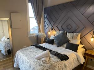 a bedroom with a large bed with a large wooden headboard at Just Off Long - Inner City Gem in Cape Town