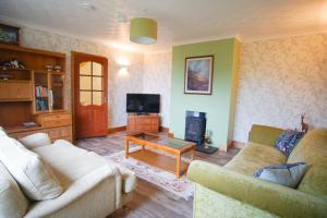 a living room with two couches and a tv at Remuera, North Tolsta in North Tolsta