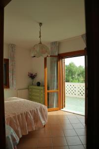 1 dormitorio con 1 cama y puerta corredera de cristal en Casa Vacanze Le Terrazze, en Terrasini