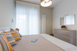 a bedroom with a large bed with a large window at Residence Armony in Misano Adriatico