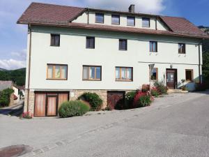 a large white house on a street at Apartment 43 in Oberhöflein