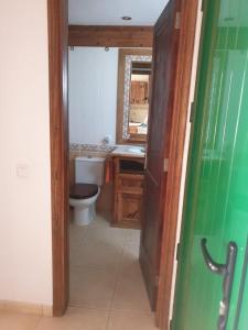 a bathroom with a toilet and a sink at CASA SARA in Parque Holandes +13 photos
