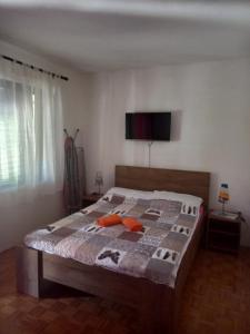 a bedroom with a bed with a television on the wall at Dubravka 1 in Funtana +38 photos