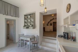 a kitchen and dining room with a table and chairs at Sunset Studio in Plaka Milou