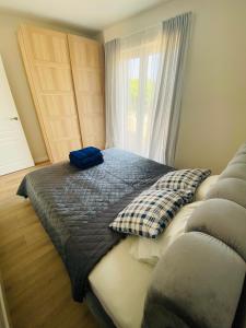 a bedroom with a bed with a pillow on it at KoKo House Palanga in Palanga